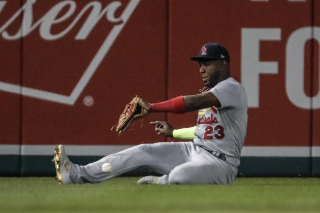 St. Louis Cardinals' Marcell Ozuna can't catch a ball hit by Washington Nationals' Anthony Rendon during the third inning of Game 3 of the baseball National League Championship Series Monday, Oct. 14, 2019, in Washington. Adam Eaton scored on the play. (AP Photo/Jeff Roberson)