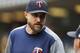 Minnesota Twins manager Rocco Baldelli talks to a coach during the seventh inning of a baseball game against the Detroit Tigers, Sunday, Sept. 1, 2019, in Detroit. (AP Photo/Carlos Osorio)