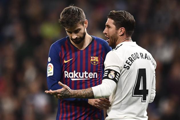 Real Madrid's Spanish defender Sergio Ramos (R) talks with Barcelona's Spanish defender Gerard Pique during the Spanish league football match between Real Madrid CF and FC Barcelona at the Santiago Bernabeu stadium in Madrid on March 2, 2019. (Photo by OSCAR DEL POZO / AFP)        (Photo credit should read OSCAR DEL POZO/AFP via Getty Images)