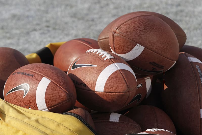 A bag of footballs sits on the field before the start of the Oklahoma-Kansas State NCAA college football game in Norman, Okla., Saturday, Sept. 22, 2012. (AP Photo/Sue Ogrocki)