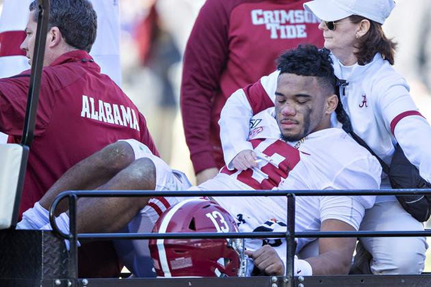 FAYETTEVILLE, AR - NOVEMBER 9:   Tua Tagovailoa #13 of the Alabama Crimson Tide is helped off the field after being injured on a play in the first half of a game against the Mississippi State Bulldogs at Davis Wade Stadium on November 16, 2019 in Starkville, Mississippi.  (Photo by Wesley Hitt/Getty Images)