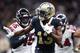 New Orleans Saints wide receiver Michael Thomas (13) carries on a pass reception ahead of Atlanta Falcons linebacker Deion Jones (45) and defensive end Vic Beasley (44) in the first half of an NFL football game in New Orleans, Sunday, Nov. 10, 2019. (AP Photo/Rusty Costanza)