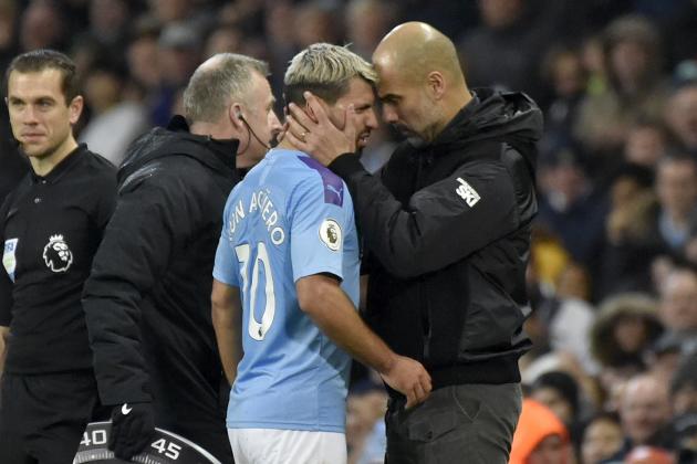 Manchester City's head coach Pep Guardiola, right, talks with Sergio Aguero as he is substituted after getting injured during the English Premier League soccer match between Manchester City and Chelsea at Etihad stadium in Manchester, England, Saturday, Nov. 23, 2019. (AP Photo/Rui Vieira)