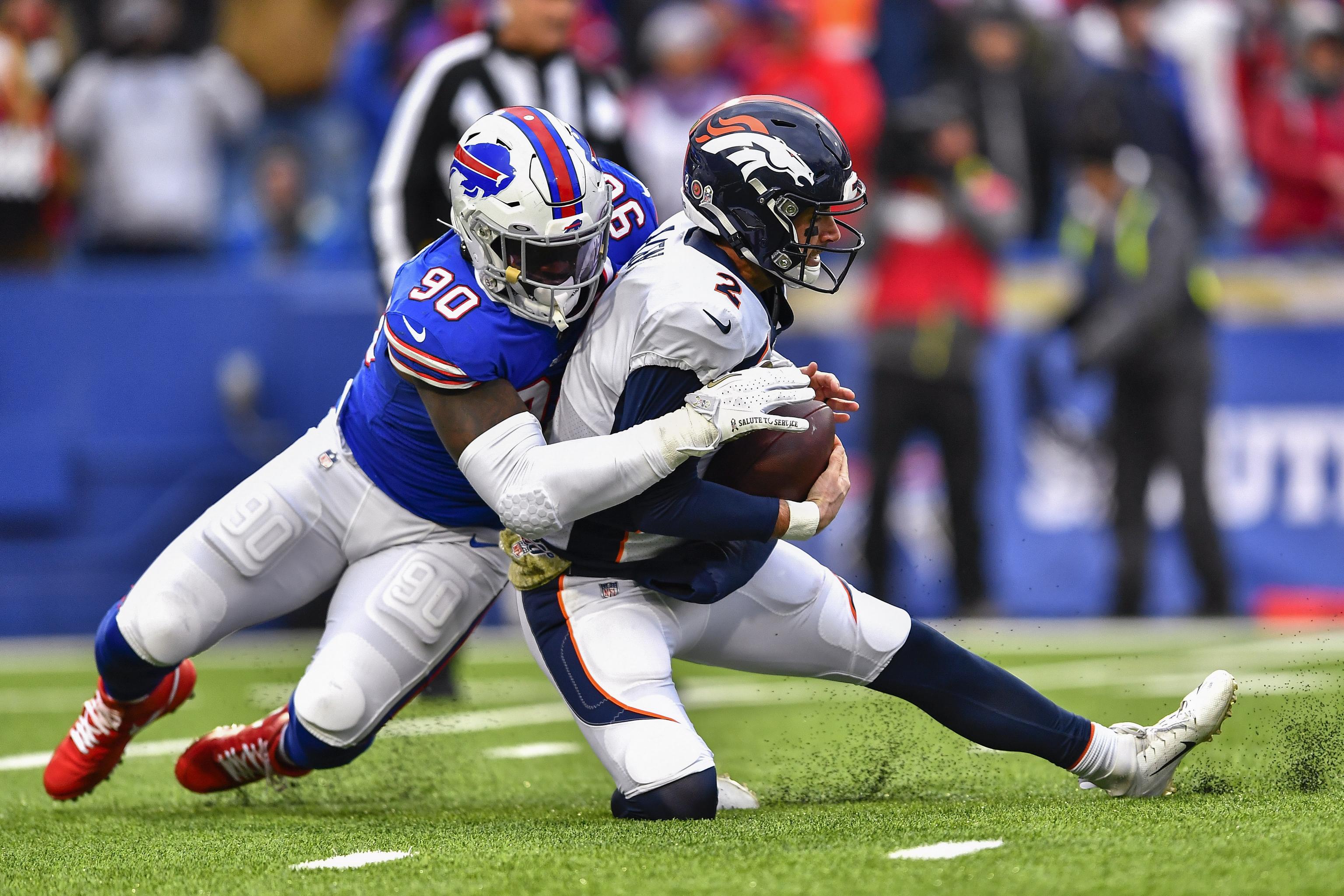 Buffalo Bills' Shaq Lawson, left, greets Denver Broncos' DeShawn