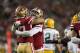 San Francisco 49ers defensive end Arik Armstead, center, is congratulated by defensive end Nick Bosa, left, after sacking Green Bay Packers quarterback Aaron Rodgers (12) during the first half of an NFL football game in Santa Clara, Calif., Sunday, Nov. 24, 2019. (AP Photo/Tony Avelar)