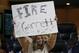 A young fan holds a sign calling for the firing of Dallas Cowboys head coach Jason Garrett in the second half of an NFL football game against the Buffalo Bills in Arlington, Texas, Thursday, Nov. 28, 2019. (AP Photo/Ron Jenkins)