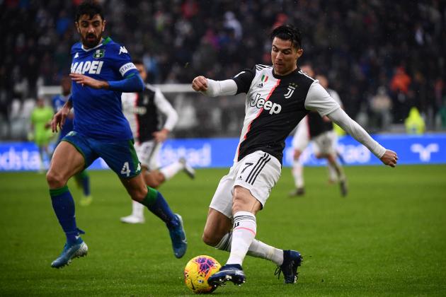Sassuolo's Italian midfielder Francesco Magnanelli (R) fights for the ball with Juventus' Portuguese forward Cristiano Ronaldo during the Italian Serie A football match Juventus vs Sassuolo on December 1, 2019, at the Juventus Allianz stadium in Turin. (Photo by MARCO BERTORELLO / AFP) (Photo by MARCO BERTORELLO/AFP via Getty Images)