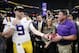 LSU quarterback Joe Burrow and LSU head coach Ed Orgeron celebrate after the Southeastern Conference championship NCAA college football game against Georgia, Saturday, Dec. 7, 2019, in Atlanta. LSU won 37-10. (AP Photo/John Bazemore)