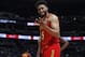Atlanta Hawks forward Jabari Parker laughs as he tells a fan that he has four fouls, not five, late in the second half of the team's NBA basketball game against the Denver Nuggets on Tuesday, Nov. 12, 2019, in Denver. Atlanta won 125-121. (AP Photo/David Zalubowski)
