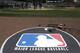 The Major League Baseball logo serves as the visitor's on deck circle before a baseball game between the Chicago White Sox and the Cleveland Indians Wednesday, April 24, 2013, in Chicago. (AP Photo/Charles Rex Arbogast)