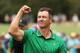 MELBOURNE, AUSTRALIA - DECEMBER 13: Adam Scott of Australia and the International team celebrates after he and Louis Oosthuizen of South Africa and the International team defeated Dustin Johnson of the United States team and Matt Kuchar of the United States team 3&2 during Friday foursome matches on day two of the 2019 Presidents Cup at Royal Melbourne Golf Course on December 13, 2019 in Melbourne, Australia. (Photo by Rob Carr/Getty Images)