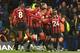 Bournemouth's English midfielder Dan Gosling celebrates with teammates after he scores his team's first goal, ruled offside but overruled by VAR, during the English Premier League football match between Chelsea and Bournemouth at Stamford Bridge in London on December 14, 2019. (Photo by OLLY GREENWOOD / AFP) / RESTRICTED TO EDITORIAL USE. No use with unauthorized audio, video, data, fixture lists, club/league logos or 'live' services. Online in-match use limited to 120 images. An additional 40 images may be used in extra time. No video emulation. Social media in-match use limited to 120 images. An additional 40 images may be used in extra time. No use in betting publications, games or single club/league/player publications. / (Photo by OLLY GREENWOOD/AFP via Getty Images)