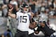 Jacksonville Jaguars quarterback Gardner Minshew throws the ball as Oakland Raiders defensive end Clelin Ferrell looks on during the second half of an NFL football game in Oakland, Calif., Sunday, Dec. 15, 2019. (AP Photo/D. Ross Cameron)