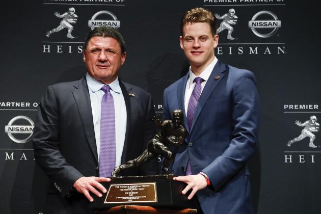 NCAA college football player, LSU quarterback Joe Burrow, right, and head coach Ed Orgeron pose for a photo after Burrow wins the Heisman Trophy, Saturday, Dec. 14, 2019, in New York. (AP Photo/Jason Szenes)