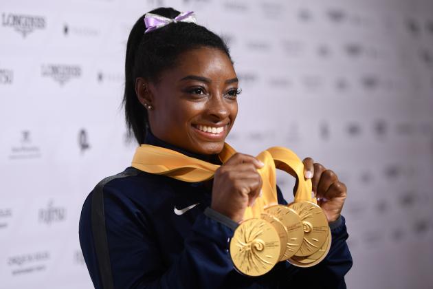 STUTTGART, GERMANY - OCTOBER 13: Simone Biles of USA poses with her Medal haul after the Apparatus Finals on Day 10 of the FIG Artistic Gymnastics World Championships at Hanns Martin Schleyer Hall  on October 13, 2019 in Stuttgart, Germany. (Photo by Laurence Griffiths/Getty Images)