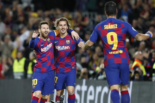 Barcelona's Lionel Messi, left, celebrates after scoring his side's second goal with Antoine Griezmann, centre and Luis Suarez during a Champions League soccer match Group F between Barcelona and Dortmund at the Camp Nou stadium in Barcelona, Spain, Wednesday, Nov. 27, 2019. (AP Photo/Joan Monfort)