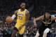 Los Angeles Lakers' LeBron James dribbles past Milwaukee Bucks' Giannis Antetokounmpo during the first half of an NBA basketball game Thursday, Dec. 19, 2019, in Milwaukee. (AP Photo/Morry Gash)