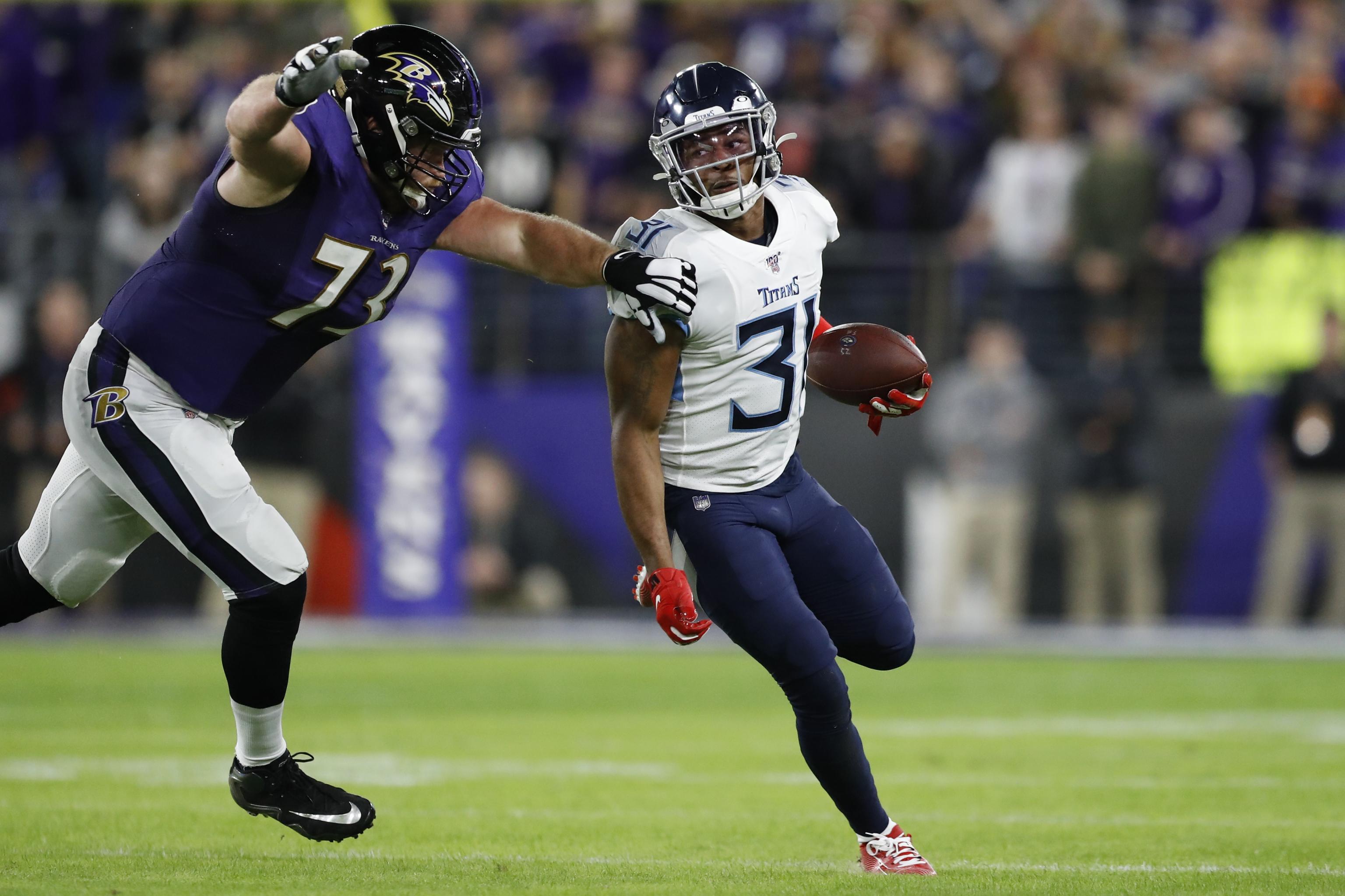 Baltimore Ravens' Marshal Yanda spits at Bengals' Vontaze Burfict