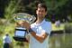 Serbia's Novak Djokovic poses for photographs with the championship trophy at the Royal Botanical Gardens in Melbourne on January 28, 2019, a day after his victory against Spain's Rafael Nadal in the men's singles final of the Australian Open tennis tournament. (Photo by William WEST / AFP) / -- IMAGE RESTRICTED TO EDITORIAL USE - STRICTLY NO COMMERCIAL USE -- (Photo credit should read WILLIAM WEST/AFP via Getty Images)