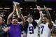 LSU head coach Ed Orgeron holds the trophy beside quarterback Joe Burrow, center, and safety Grant Delpit after a NCAA College Football Playoff national championship game against Clemson, Monday, Jan. 13, 2020, in New Orleans. LSU won 42-25. (AP Photo/Sue Ogrocki)