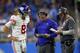 New York Giants quarterback Daniel Jones (8) waits for a play from head coach Pat Shurmur, middle, and offensive coordinator Mike Shula during an NFL football game in Detroit, Sunday, Oct. 27, 2019. (AP Photo/Paul Sancya)