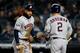 NEW YORK, NEW YORK - OCTOBER 18: George Springer #4 of the Houston Astros celebrates with Alex Bregman #2 after scoring a run off of a wild pitch thrown by James Paxton #65 of the New York Yankees during the first inning in game five of the American League Championship Series at Yankee Stadium on October 18, 2019 in New York City. (Photo by Mike Stobe/Getty Images)