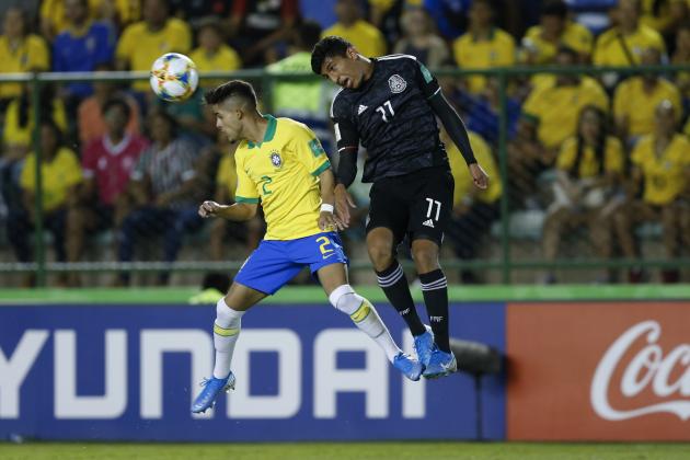 Brazil's Yan Couto, left, and Mexico's Bryan Gonzalez go for a header during the FIFA U-17 World Cup Brazil 2019 final soccer match at Arena Bezerrao in Brasilia, Brazil, Sunday, Nov. 17, 2019. (AP Photo/Eraldo Peres)