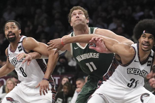 Brooklyn Nets center Jarrett Allen, right, and guard Spencer Dinwiddie, left, and Milwaukee Bucks center Brook Lopez, center, jostle for a rebound, during a NBA basketball game, Saturday Jan. 18, 2020 in New York. (AP Photo/Bebeto Matthews)