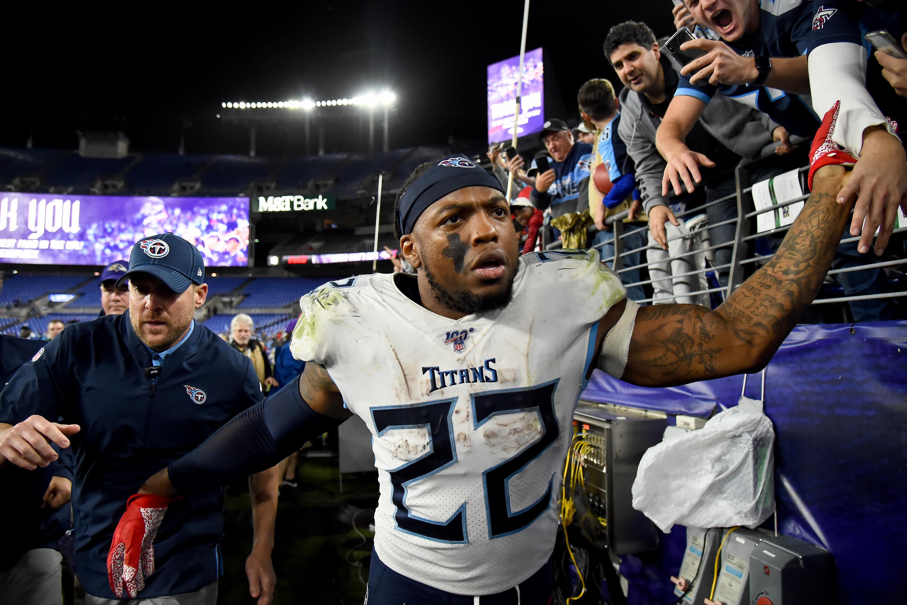 Titans running back Derrick Henry and the crown given to him by a fan