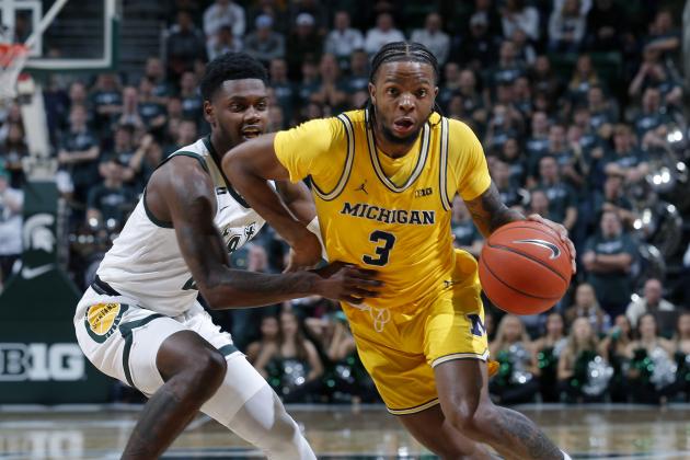 Michigan's Zavier Simpson, right, drives against Michigan State's Rocket Watts during the firsat half of an NCAA college basketball game, Sunday, Jan. 5, 2020, in East Lansing, Mich. Michigan State won 87-69. (AP Photo/Al Goldis)