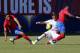 United States forward Ulysses Llanez, center, slides between Costa Rica midfielder Yeltsin Tejeda, left, and defender Keysher Fuller (4) during the first half of an international friendly soccer match in Carson, Calif., Saturday, Feb. 1, 2020. (AP Photo/Ringo H.W. Chiu)