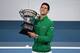Serbia's Novak Djokovic holds the Norman Brookes Challenge Cup trophy after beating Austria's Dominic Thiem in their men's singles final match on day fourteen of the Australian Open tennis tournament in Melbourne on February 3, 2020. (Photo by John DONEGAN / AFP) / IMAGE RESTRICTED TO EDITORIAL USE - STRICTLY NO COMMERCIAL USE (Photo by JOHN DONEGAN/AFP via Getty Images)