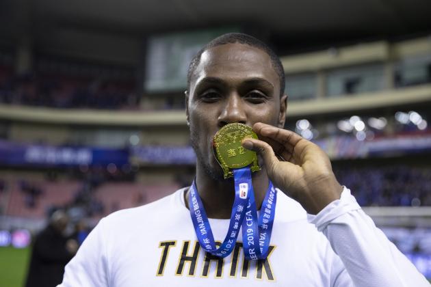 SHANGHAI, CHINA - DECEMBER 06: Odion Ighalo of Shanghai Greenland Shenhua and teammates celebrate with the trophy during the award ceremony after the 2019 CFA Cup Final - Shanghai Greenland Shenhua v Shandong Luneng Taishan at Shanghai Hongkou Football Stadium on December 6, 2019 in Shanghai, China.  (Photo by Fred Lee/Getty Images)