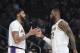 Los Angeles Lakers forward Anthony Davis, left, slaps hands with guard LeBron James during an NBA basketball game against the Dallas Mavericks Sunday, Dec. 29, 2019, in Los Angeles. (AP Photo/Michael Owen Baker)