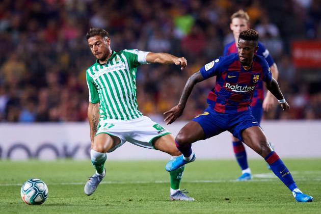 BARCELONA, SPAIN - AUGUST 25: Joaquin Sanchez of Real Betis fights for the ball with Nelson Semedo of FC Barcelona during the Liga match between FC Barcelona and Real Betis Balompie at Camp Nou on August 25, 2019 in Barcelona, Spain. (Photo by Alex Caparros/Getty Images)