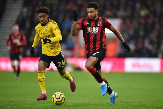 Arsenal's English midfielder Reiss Nelson (L) vies with Bournemouth's Norwegian striker Joshua King during the English Premier League football match between Bournemouth and Arsenal at the Vitality Stadium in Bournemouth, southern England on December 26, 2019. (Photo by Glyn KIRK / AFP) / RESTRICTED TO EDITORIAL USE. No use with unauthorized audio, video, data, fixture lists, club/league logos or 'live' services. Online in-match use limited to 120 images. An additional 40 images may be used in extra time. No video emulation. Social media in-match use limited to 120 images. An additional 40 images may be used in extra time. No use in betting publications, games or single club/league/player publications. /  (Photo by GLYN KIRK/AFP via Getty Images)