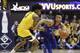 Kansas guard Devon Dotson (1) is defended by West Virginia guard Miles McBride (4) during the first half of an NCAA college basketball game Wednesday, Feb. 12, 2020, in Morgantown, W.Va. (AP Photo/Kathleen Batten)