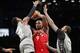 Brooklyn Nets guard Caris LeVert (22) and Nets forward Wilson Chandler (21) defend Toronto Raptors center Serge Ibaka (9) during the first quarter of an NBA basketball game, Wednesday, Feb. 12, 2020, in New York. (AP Photo/Kathy Willens)
