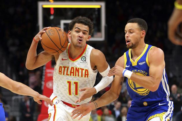 Atlanta Hawks guard Trae Young, left, drives against Golden State Warriors guard Stephen Curry, right, during the first half of an NBA basketball game Monday, Dec. 3, 2018, in Atlanta. (AP Photo/John Bazemore)