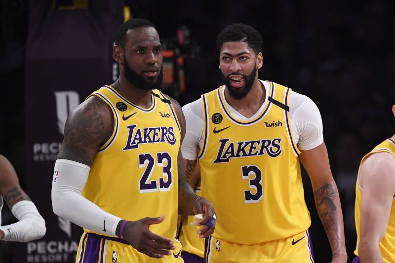 Los Angeles Lakers forward LeBron James, left, stands with forward Anthony Davis during the second half of an NBA basketball game against the Memphis Grizzlies Friday, Feb. 21, 2020, in Los Angeles. The Lakers won 117-105. (AP Photo/Mark J. Terrill)