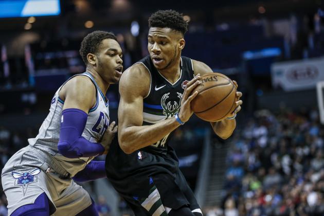 Milwaukee Bucks forward Giannis Antetokounmpo, right, looks to drive against Charlotte Hornets forward P.J. Washington in the first half of an NBA basketball game in Charlotte, N.C., Sunday, March 1, 2020. (AP Photo/Nell Redmond)