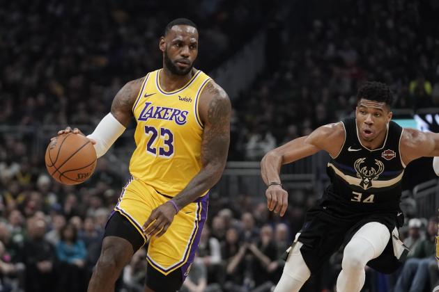 Los Angeles Lakers' LeBron James dribbles past Milwaukee Bucks' Giannis Antetokounmpo during the first half of an NBA basketball game Thursday, Dec. 19, 2019, in Milwaukee. (AP Photo/Morry Gash)