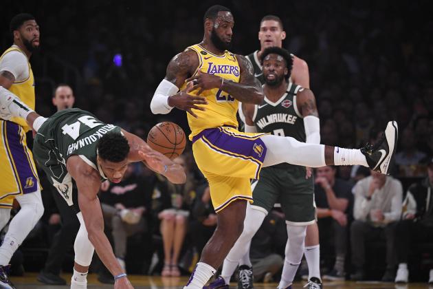 Milwaukee Bucks forward Giannis Antetokounmpo, second from left, and Los Angeles Lakers forward LeBron James collide during the first half of an NBA basketball game Friday, March 6, 2020, in Los Angeles. (AP Photo/Mark J. Terrill)