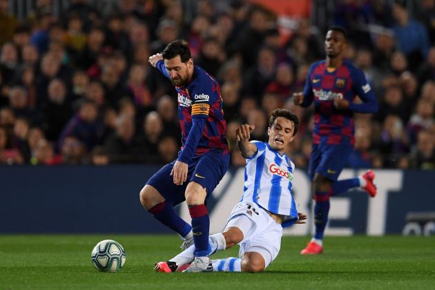 BARCELONA, SPAIN - MARCH 07: Lionel Messi of FC Barcelona is tackled by Ander Guevara of Real Sociedad during the La Liga match between FC Barcelona and Real Sociedad at Camp Nou on March 07, 2020 in Barcelona, Spain. (Photo by Alex Caparros/Getty Images)