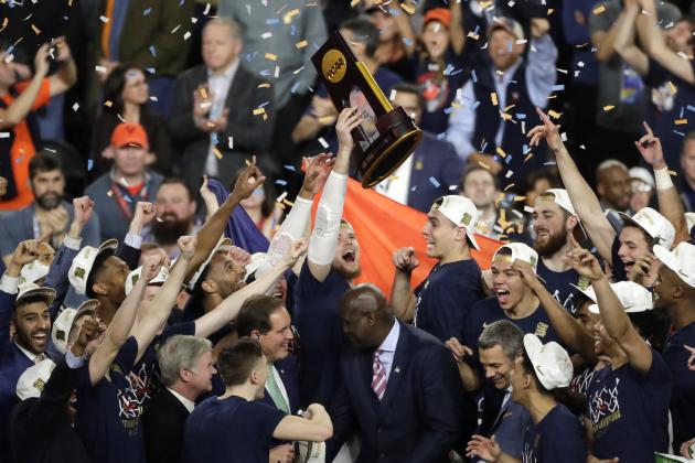 Virginia players celebrate with the trophy after defeating Texas Tech 85-77 in the championship game in the Final Four NCAA college basketball tournament, Monday, April 8, 2019, in Minneapolis. (AP Photo/Matt York)