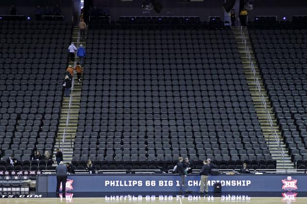 Fans leave the Sprint Center after the remaining NCAA college basketball games after in  the Big 12 Conference tournament were cancelled due to concerns about the coronavirus Thursday, March 12, 2020, in Kansas City, Mo. (AP Photo/Charlie Riedel)
