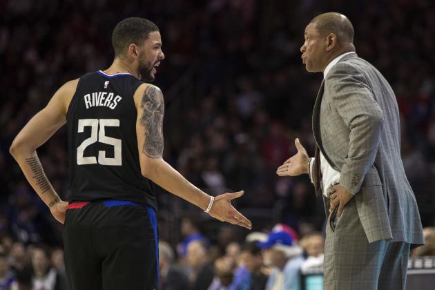 Los Angeles Clippers' head coach Doc Rivers, right, talks with Austin Rivers, left, during the first half of an NBA basketball game against the Philadelphia 76ers, Saturday, Feb. 10, 2018, in Philadelphia. (AP Photo/Chris Szagola)