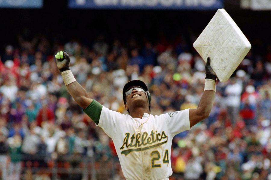 Oakland As Rickey Henderson holds third base over his head after breaking  Ty Cobbs career stole base record against the Toronto Blue Jays at the  Oakland Coliseum, Tuesday, May 29, 1990, Oakland