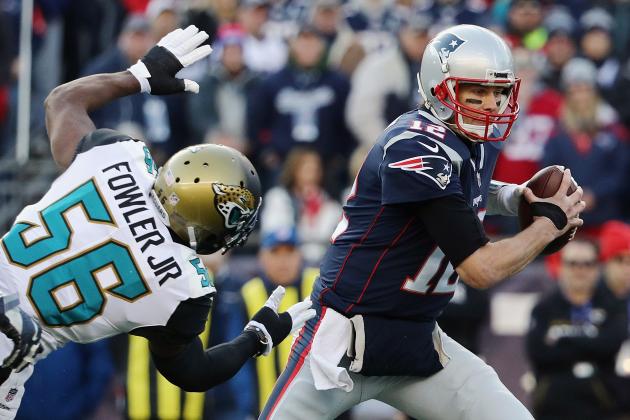 FOXBOROUGH, MA - JANUARY 21:  Tom Brady #12 of the New England Patriots is pursued by Dante Fowler Jr. #56 of the Jacksonville Jaguars in the first quarter during the AFC Championship Game at Gillette Stadium on January 21, 2018 in Foxborough, Massachusetts.  (Photo by Maddie Meyer/Getty Images)