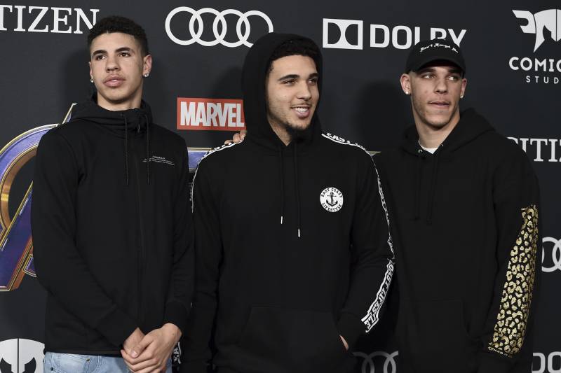 Professional basketball player Lonzo Ball, of the Los Angeles Lakers, from right, and his brothers LiAngelo Ball and LaMelo Ball arrive at the premiere of